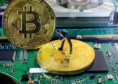 A miner inspecting his mining rig
